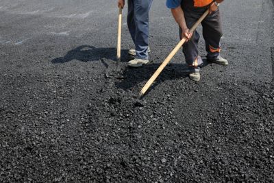 Fresh asphalt being laid on a private ranch road outside San Antonio Texas