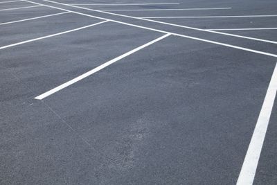 After this asphalt parking lot's been sealed and allowed to dry,  special pavement markers were added.